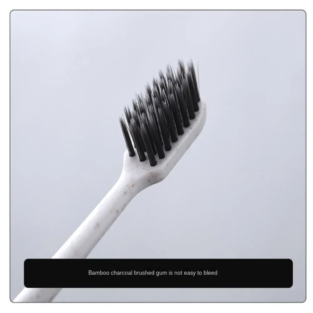 White toothbrush with black bristles on a light gray background