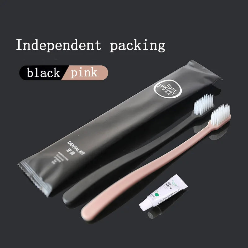 Black dental kit with a pink toothbrush and white tube on a black background